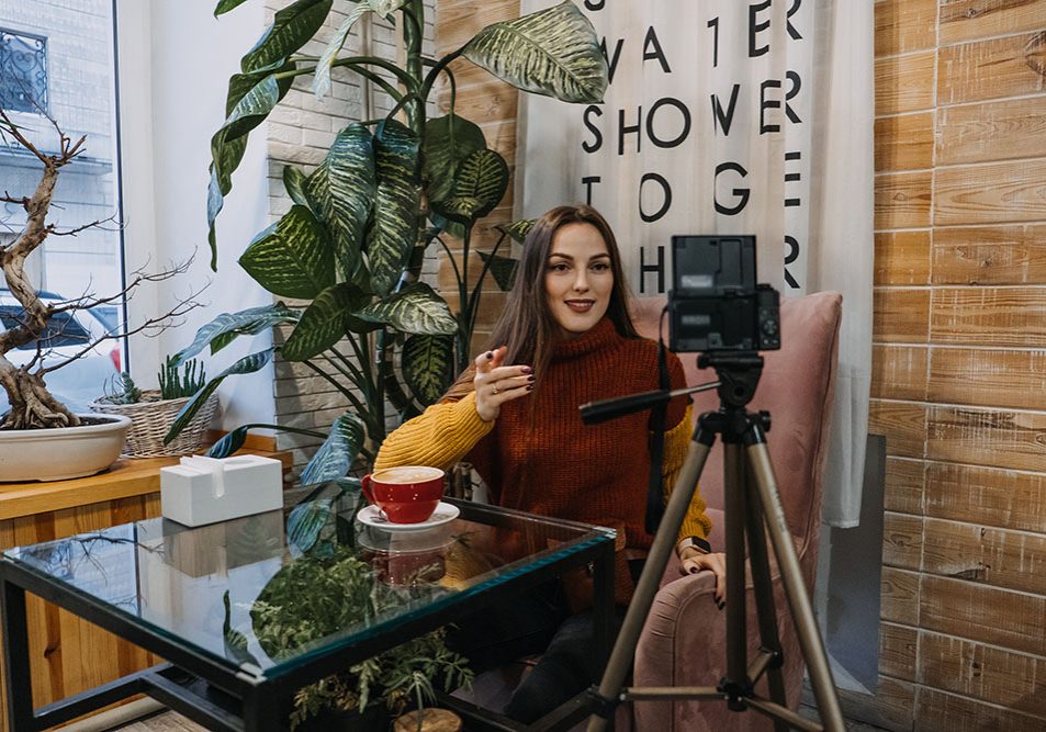 Content creator, blogger, vlogger setting up recording equipment and shooting video in cafe or home. Young woman taking selfies, filming herself <a href="https://www.corporateeducators.com.au/corporate-educators-services/marketing" rel="noopener" target="_blank">Marketing Courses</a>