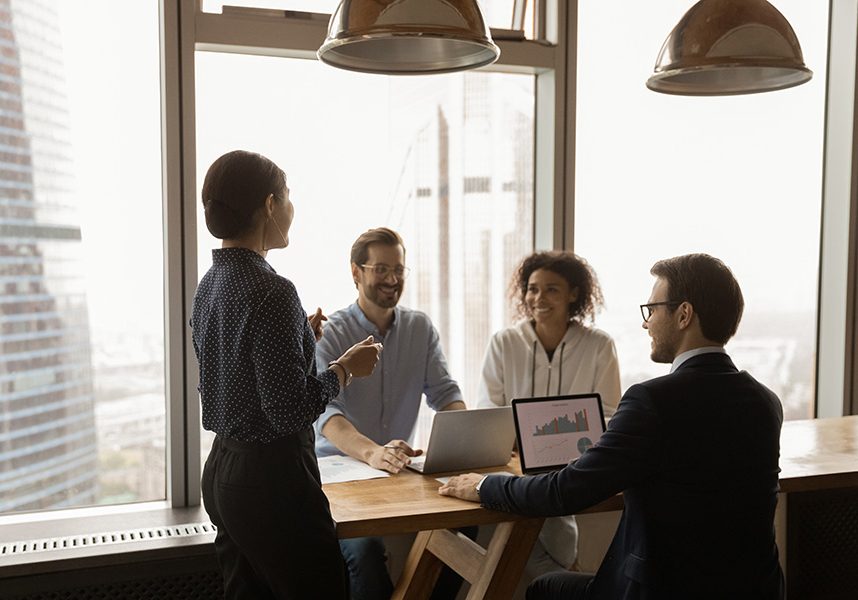 Indian businesswoman mentor leading corporate meeting in modern office Indian businesswoman mentor leading corporate meeting in modern office with panoramic windows, boardroom, smiling colleagues sharing ideas, business partners discussing project strategy, negotiating