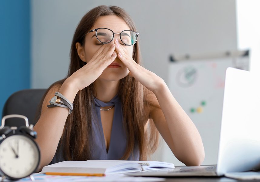 Tired businesswoman trying to meet deadline in office Tired businesswoman trying to meet deadline in office