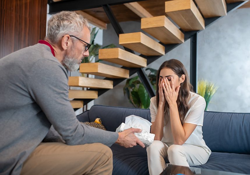 Man helping a frustrated woman to calm down Providing support. A man helping a frustrated woman to calm down